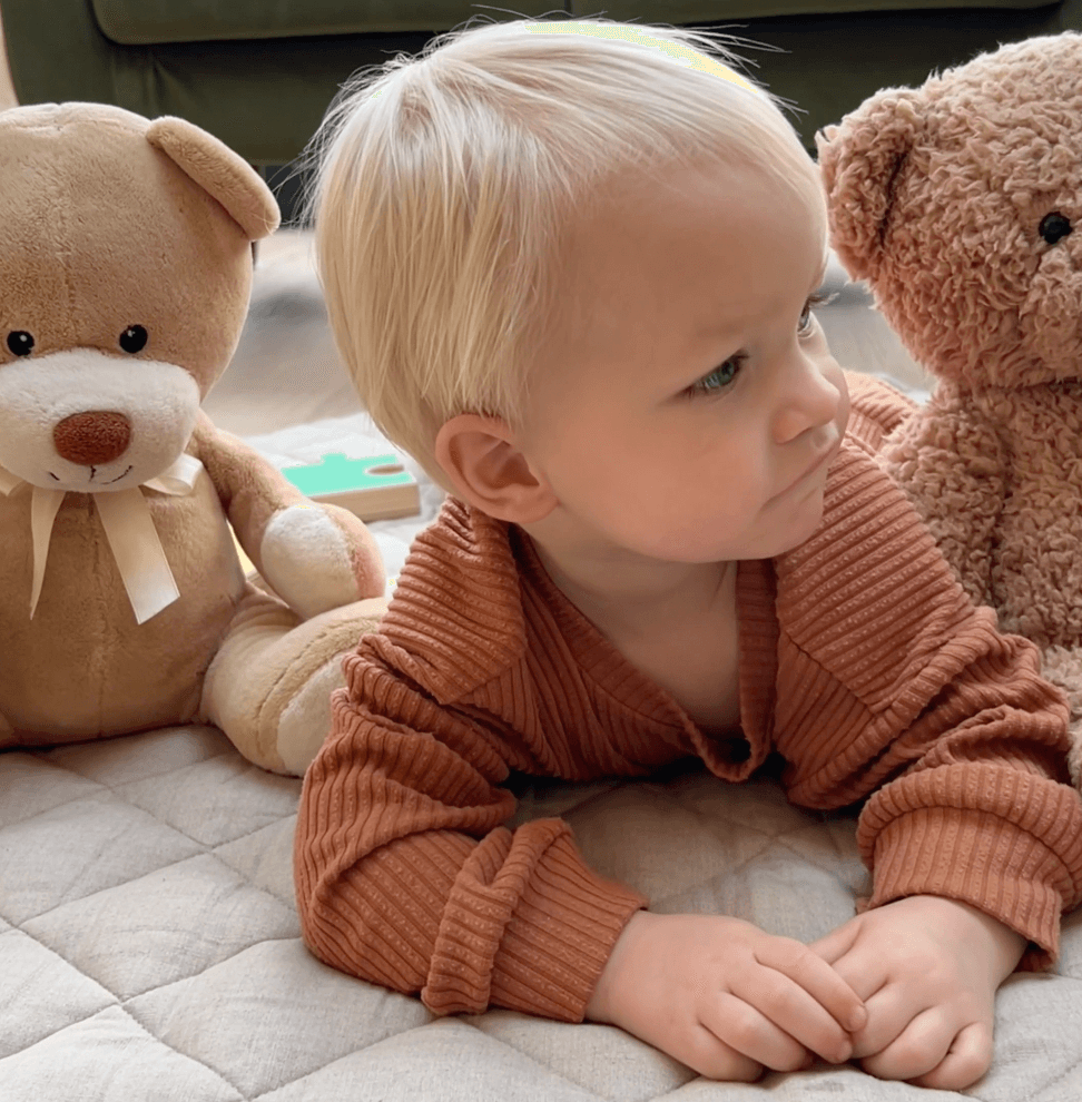 Baby playing on a quilted play mat