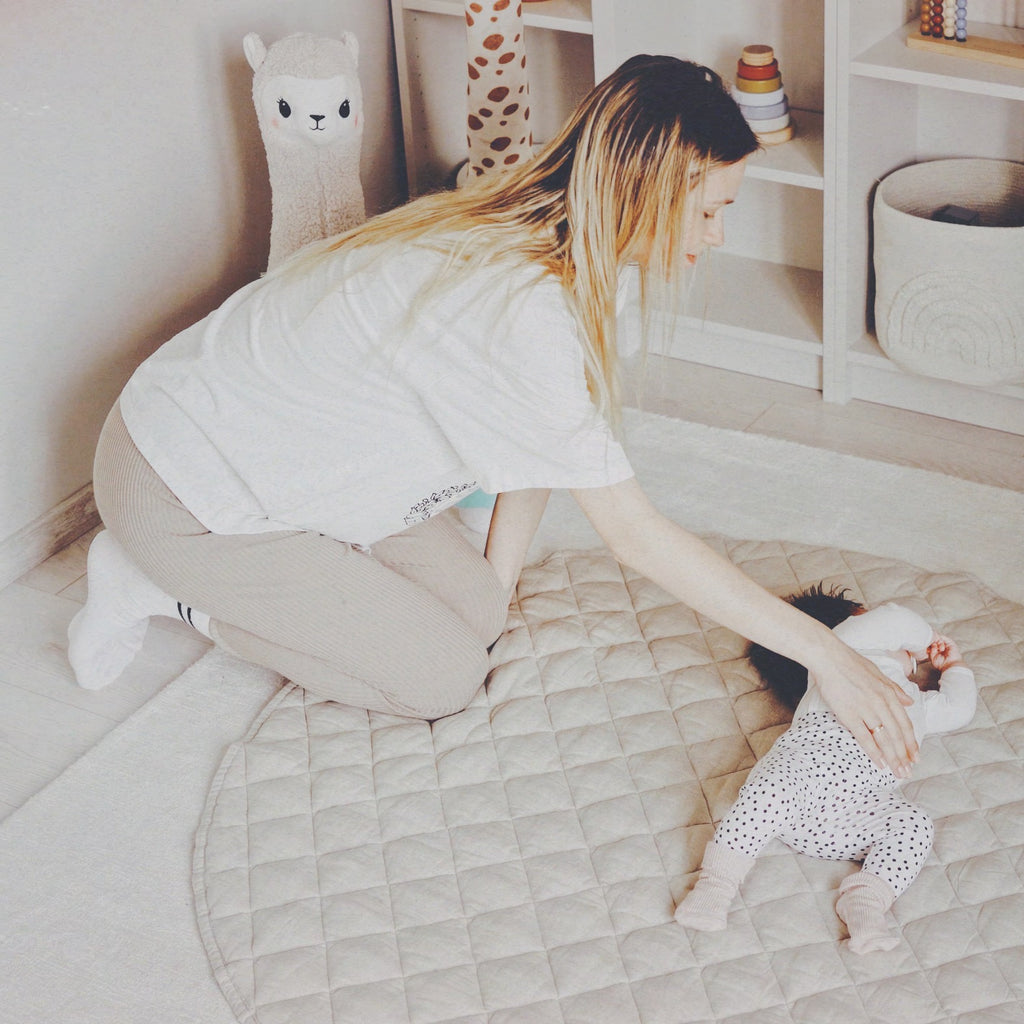 Mother playing with their baby on our Ivory Quilted Linen Baby Play Mat UK in the nursery room